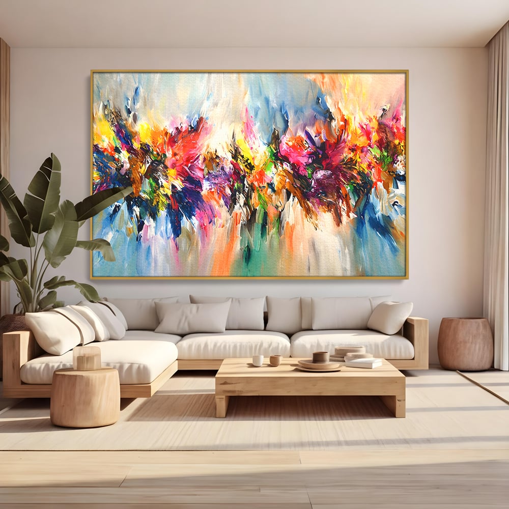 Tablou canvas cu pictura abstracta cu explozie de culoare, in rama de aluminiu auriu, pe perete intr-un living